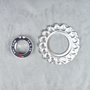 silver aluminum wheel plate for bbs rc090 wheels and an aluminum silver adapter with a black top and letters rc x rs and moding on top